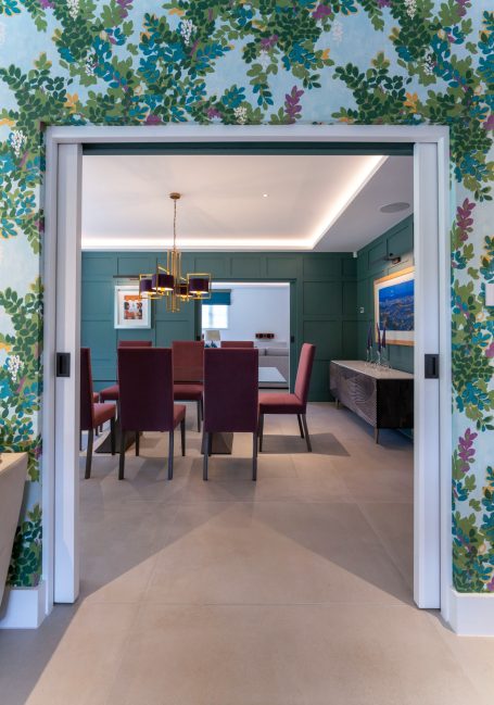 Interior view of a dining room with floral wallpaper and a contemporary design.